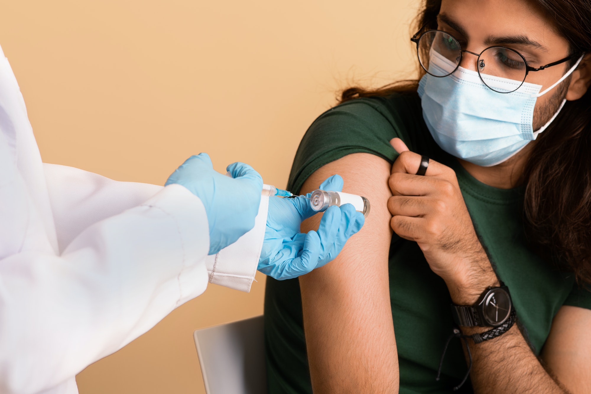 Closeup of nurse hands holding vaccine and syringe